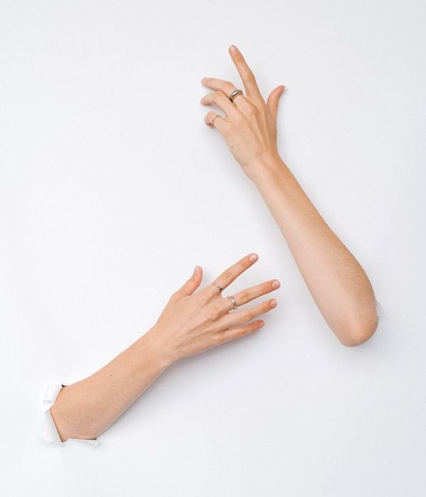 Person in a flowing movement pose against a clean white background.